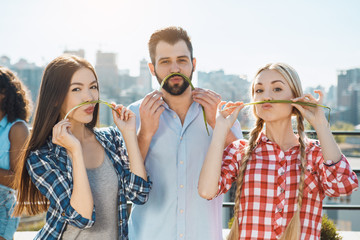 Group of friends having barbecue party on the roof