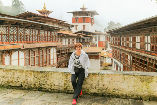 Beautiful Caucasian woman smiling to the camera in Trongsa Dzong Bumthang, Bhutan.