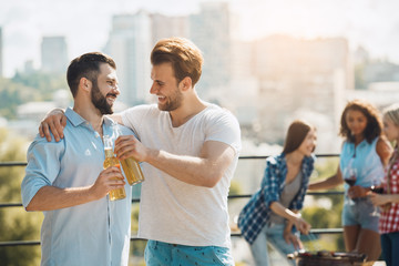 Group of friends having barbecue party on the roof