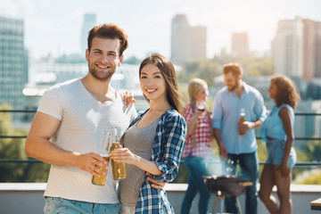 Group of friends having barbecue party on the roof
