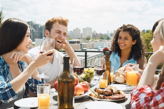 Group of friends having barbecue party on the roof