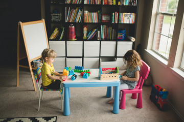 Siblings playing at homeschool table