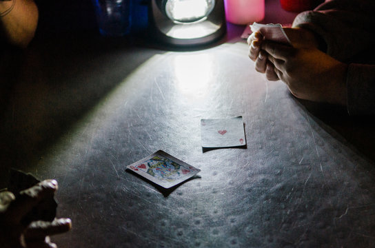 playing cards by camp lantern