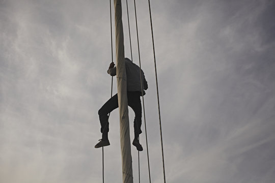 Captain climbs the jib.
