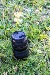 a telephoto lens standing in green grass
