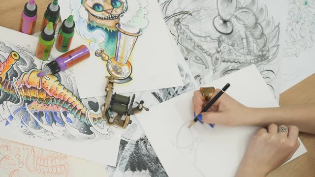 Tattoo-artist draws the sketches for tattoo
