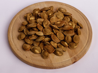 A bunch apricot seeds on a wooden plate