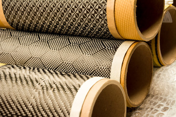 Black carbon fiber composite raw material close up background