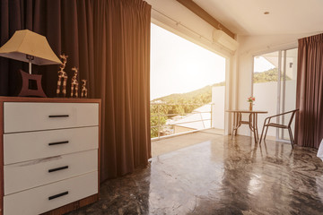 Modern living room interior design with big balcony,  concrete floor and stairs to second floor