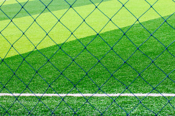 Photo of a green synthetic grass sports field with white line shot from above