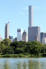 View of Manhattan skyscrapers from Central Park pond in New York City