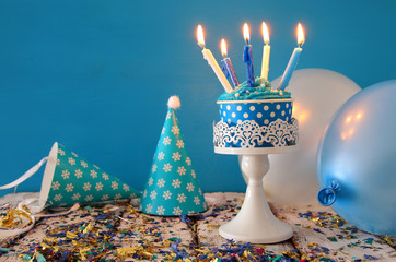 Birthday concept with cupcake and candles on wooden table