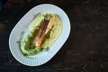 Baked trout with sauce and broccoli