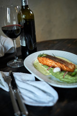 Baked trout with sauce and broccoli