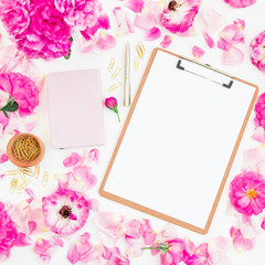 Blogger of freelancer composition. Workspace with clipboard, notebook, pen and pink roses on white background. Flat lay, top view.