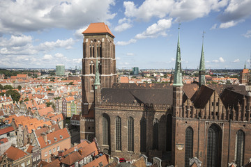 Fototapeta premium Cityscape aerial view on the old town with saint Marys church on the sunset in Gdansk, Poland