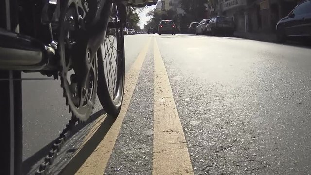 Bicycle Road / MTB /Low angle POV point of view of chain sprocket peddling on road, street, city, traffic - messenger