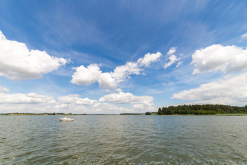 Landscape with lake in summer. Blue sky