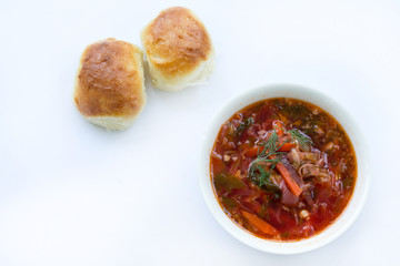 borscht with garlic buns on white background