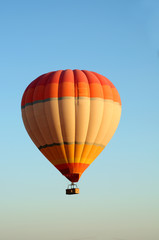 ballooning. Bright multicolored balloon against the blue sky