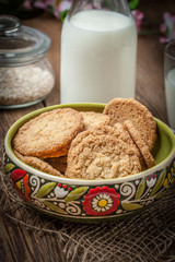 Stack of freshly baked oat biscuits in a bowl.