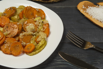 Fresh fried hot vegetables with meat and spices on the table