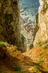 Deep ravine with blue sea below