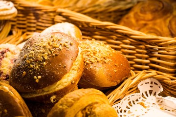 Buns with stuffing and pieces of nuts and sugar powder