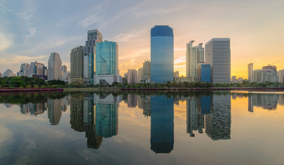 panorama high modern building city nearby the park in central city at morning with water reflection.