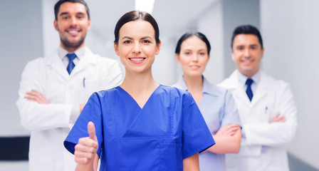 Fototapeta premium medics or doctors at hospital showing thumbs up