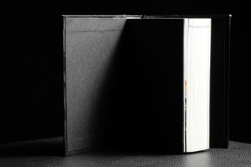 Hardcover book in black background