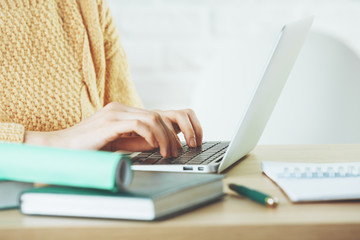 Woman typing on laptop keyboard