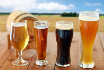 different types of beer in glasses on table