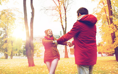 Naklejka na ściany i meble happy young couple having fun in autumn park