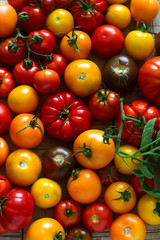 Tomato of different varieties on a wooden background