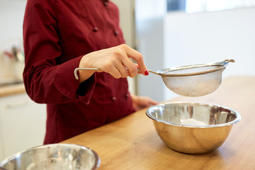 chef with flour in bowl making batter or dough