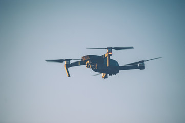Flying drone against the sky blue sky