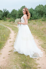 Fototapeta na wymiar portrait of young pretty woman (bride) in white wedding dress outdoors, make up and hairstyle