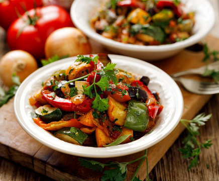Ratatouille, Vegetable stew made of zucchini, eggplants, peppers, onions, garlic and tomatoes with aromatic herbs. Traditional french food