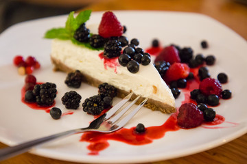 Berry cheesecake with berries on a plate in a caffe