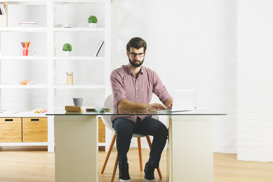 Thoughtful man using laptop