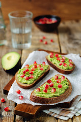 Smashed avocado pomegranate rye sandwiches