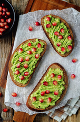 Smashed avocado pomegranate rye sandwiches