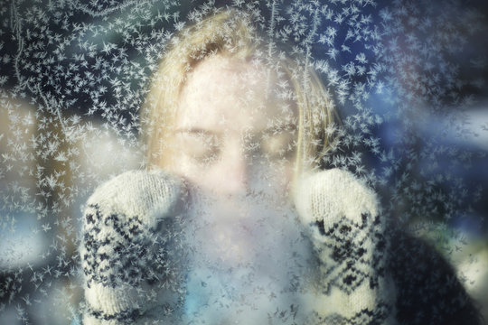 Close up of woman seen through glass during winter