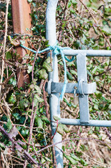 Field gate tied with rope.