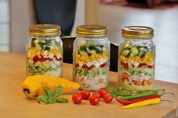 Glass jars with mixed salad, ready to go