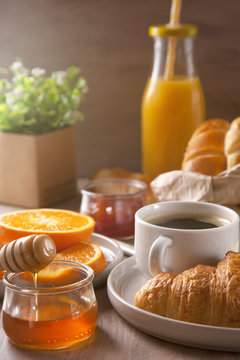 Breakfast with coffee, orange juice and croissant.