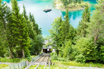 cable car at caumasee with water and trees