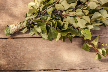 new brooms for a bath birch and oak branches on dark brown wooden background