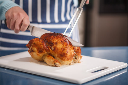 Slicing Chicken On Cutting Board